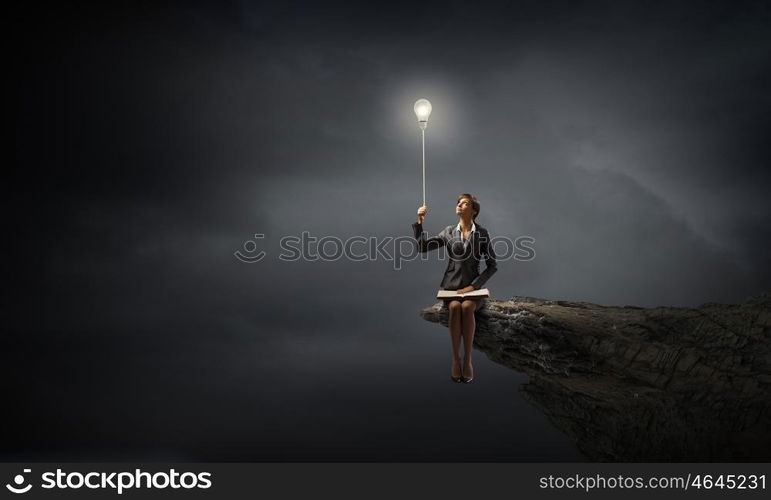 Businesswoman with book. Young smiling businesswoman sitting on bench with book on knees