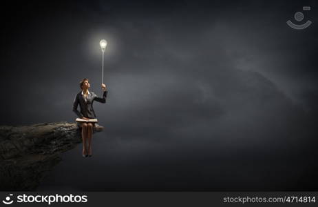 Businesswoman with book. Young smiling businesswoman sitting on bench with book on knees