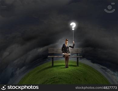 Businesswoman with book. Young smiling businesswoman sitting on bench with book on knees