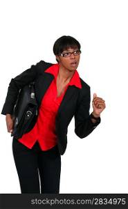 Businesswoman with briefcase about to run