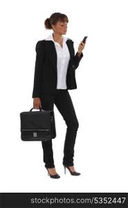 Businesswoman with briefcase and mobile