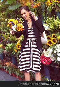 businesswoman with cell phone and flowers