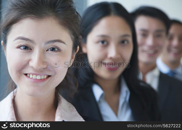 Businesswoman with co-workers portrait