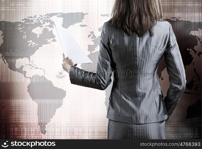 Businesswoman with documents. Rear view of businesswoman against digital blue background