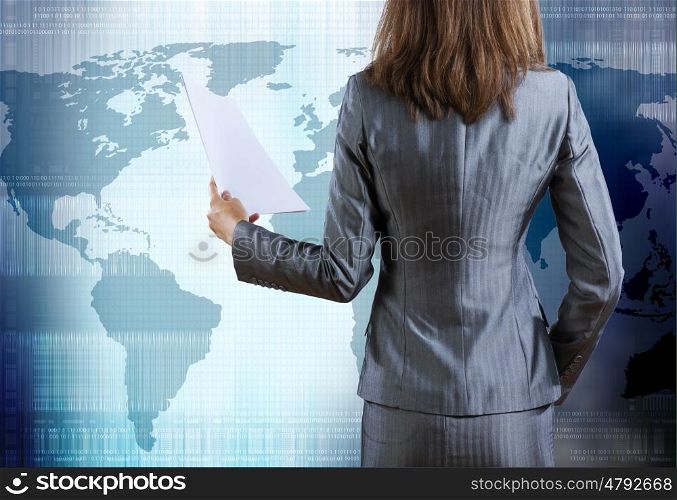 Businesswoman with documents. Rear view of businesswoman against digital blue background