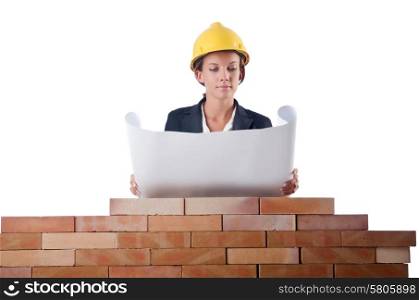 Businesswoman with drawings near brick wall