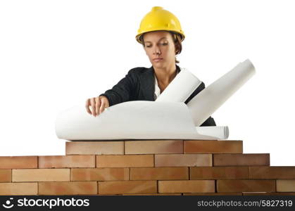 Businesswoman with drawings near brick wall