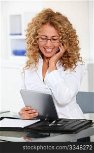 Businesswoman with electronic tab and mobile phone