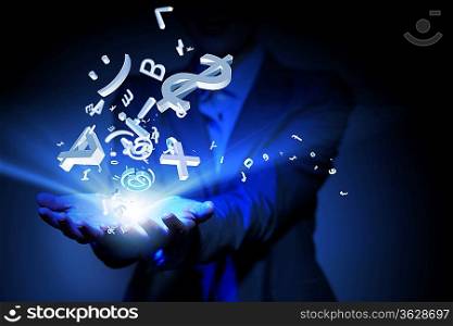 Businesswoman with financial symbols coming from her hand