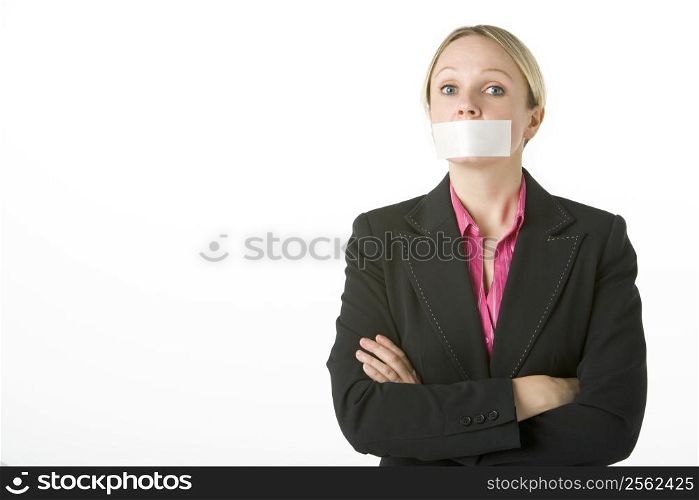 Businesswoman With Her Arms Folded And Mouth Taped Shut