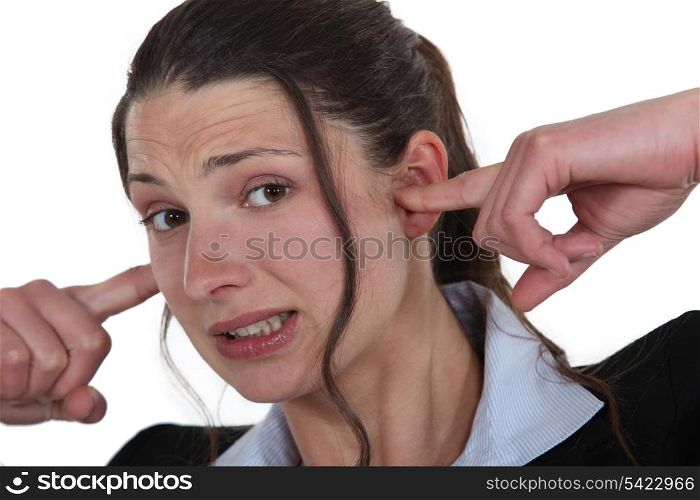 Businesswoman with her fingers in her ears