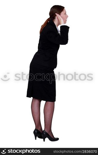 Businesswoman with her hand to her ear