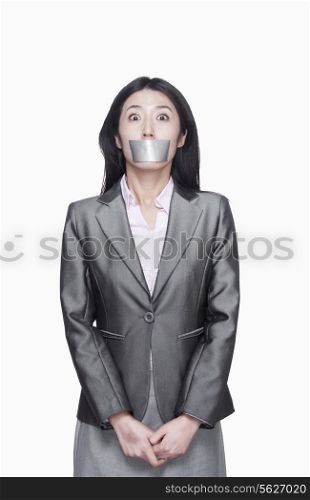 Businesswoman with her mouth caver with duct tape