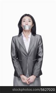 Businesswoman with her mouth caver with duct tape