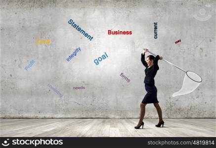 Businesswoman with hoop. Young businesswoman catching flying words with hoop