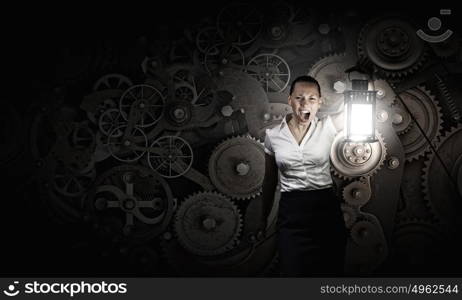 Businesswoman with lantern. Young businesswoman walking in darkness with lantern in hand