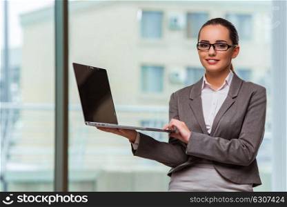 Businesswoman with laptop in business concept