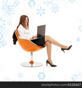 businesswoman with laptop in orange chair with snowflakes