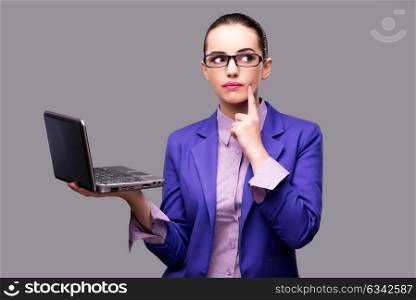 Businesswoman with laptop on gray background
