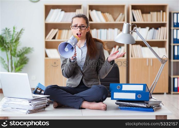 Businesswoman with loudspeaker in office