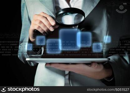 Businesswoman with magnifier glass. Businesswoman with magnifier glass examining binary code