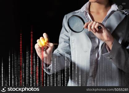 Businesswoman with magnifier glass. Businesswoman with magnifier glass examining binary code