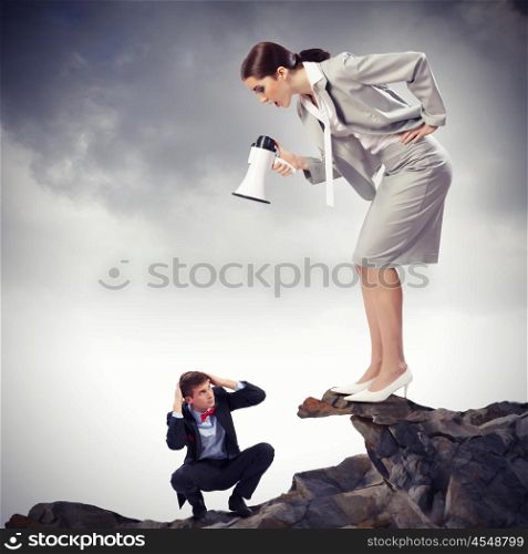 Businesswoman with megaphone. Angry businesswoman with megaphone shouting at colleague
