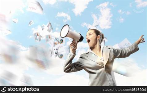 businesswoman with megaphone. businesswoman in grey suit screaming into megaphone