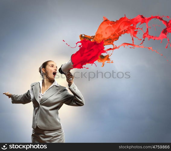 businesswoman with megaphone. businesswoman in grey suit screaming into megaphone