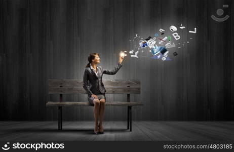 Businesswoman with mobile phone. Young businesswoman holding mobile phone with flying out icons