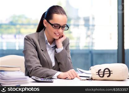 Businesswoman with money sack bag in office