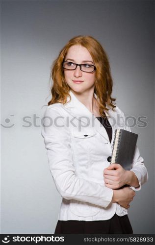 Businesswoman with notepad in the studio