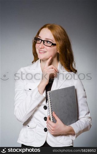 Businesswoman with notepad in the studio
