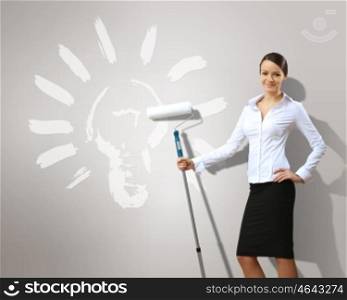 Businesswoman with paint brush and green energy symbols