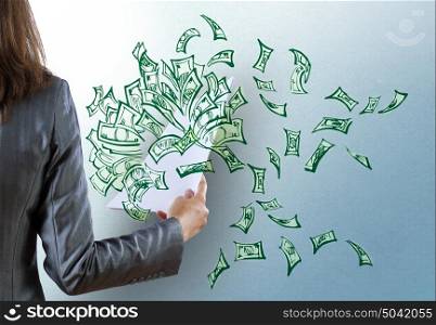 Businesswoman with papers in hand. Rear view of businesswoman and money banknotes flying in air