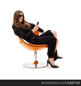 businesswoman with phone in orange chair over white