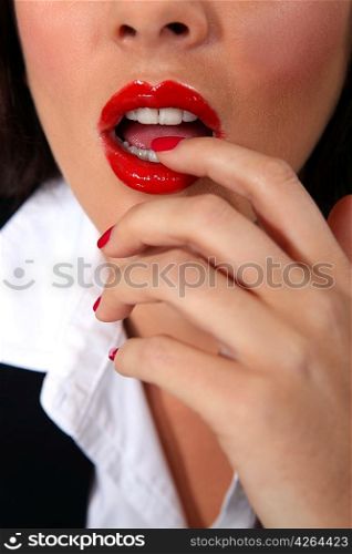 Businesswoman with red lips and nails