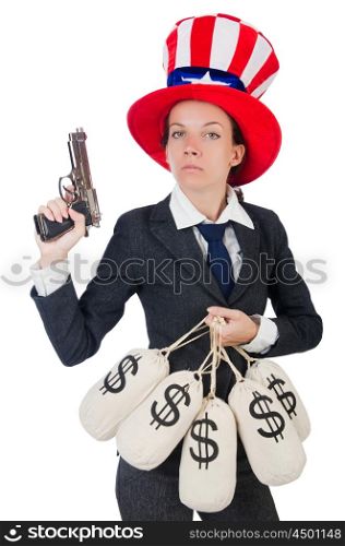 Businesswoman with sacks of money and gun isolated on white