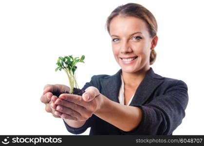 Businesswoman with seedling on white