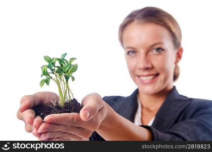 Businesswoman with seedlings and coins