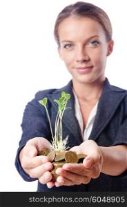 Businesswoman with seedlings and coins