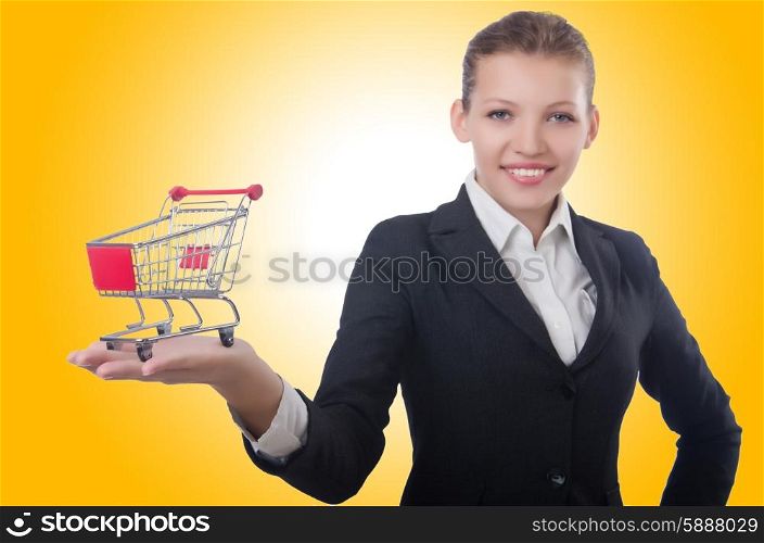 Businesswoman with shopping cart on white