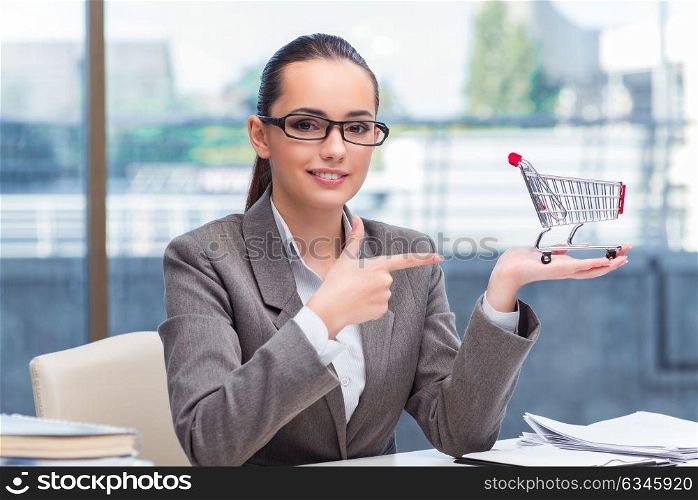 Businesswoman with small shopping cart
