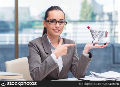 Businesswoman with small shopping cart