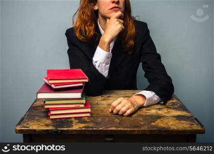 Businesswoman with stack of books