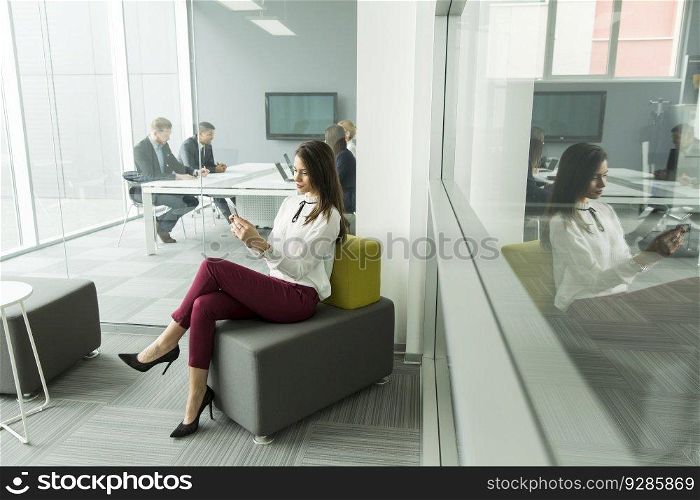 Businesswoman with the phone in the office