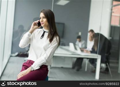 Businesswoman with the phone in the office