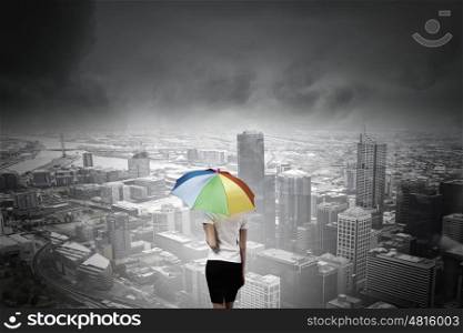 Businesswoman with umbrella. Back view of businesswoman in suit with colorful umbrella