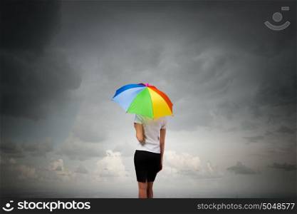 Businesswoman with umbrella. Back view of businesswoman in suit with colorful umbrella