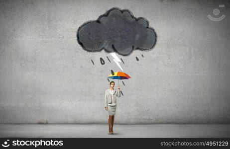 Businesswoman with umbrella. Young businesswoman with colorful umbrella under black cloud